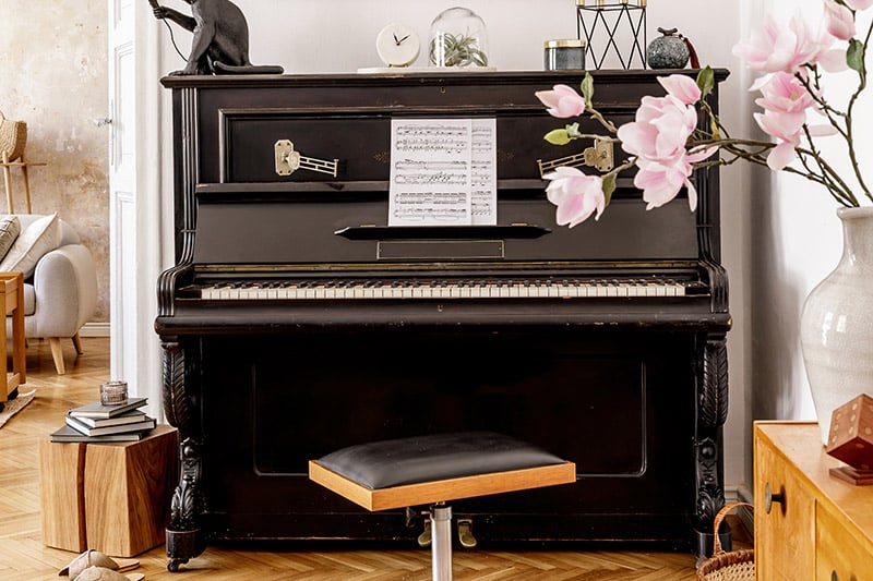 Stylish and cozy interior of living room with piano